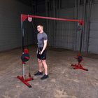 Man using a cable machine in a gym setting