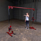 Person using a cable machine in a gym setting