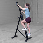 Person using Best Fitness BFMC10B Mountain Climber machine in a garage setting