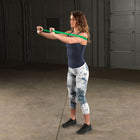 Woman exercising with resistance bands in a garage setting