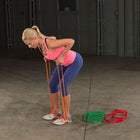 Woman exercising with resistance bands in a warehouse setting