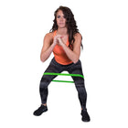 Woman exercising with a resistance band on a white background