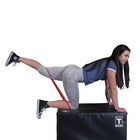 Woman exercising with resistance bands on a black box