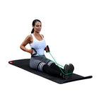 Woman exercising on a mat with resistance bands on a white background