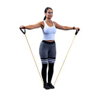 A woman performing a resistance band exercise against a solid white background. 