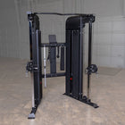 Black cable machine gym equipment in a room with gray walls and floor.