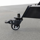 Close-up of a black caster wheel on a gray surface
