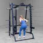 Person using a black cable machine in a gym setting