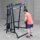 Person using a black cable machine in a gym setting