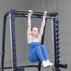 Woman exercising on a pull-up bar in a home gym setting