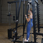 Woman exercising on a cable machine in a home gym setting