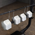Set of dumbbell spotter hooks in a gym setting