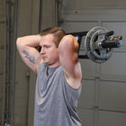 Man lifting a barbell in a gym setting