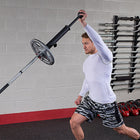 Person lifting a barbell in a gym setting