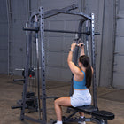 Woman exercising on a cable machine in a gym setting