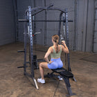 Woman exercising on a weight machine in a gym setting