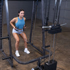 Woman exercising on a cable machine in a gym setting