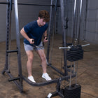Person using a cable machine in a gym setting
