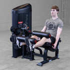 Person using a leg extension machine in a gym setting