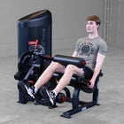 Person using a leg press machine in a gym setting