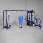 People using a cable machine in a gym setting