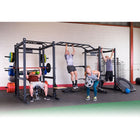 People exercising using a weightlifting cage in a gym.