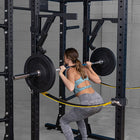 Woman performing squats with a barbell in a gym setting