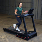 Woman using a treadmill in an indoor setting